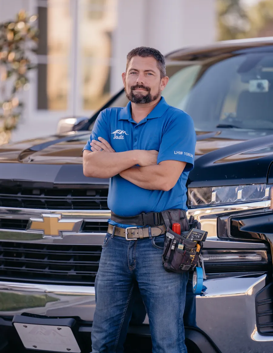 Jade LaFleur standing in front of his truck wearing his inspection tool belt